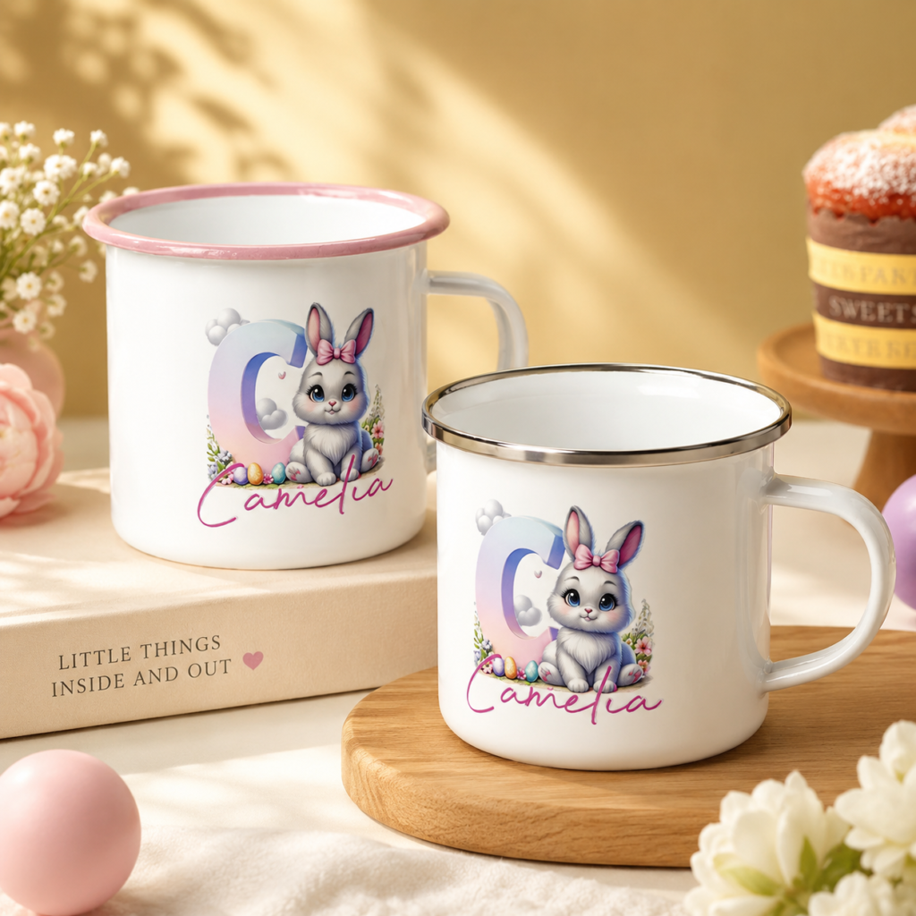 Two white mugs with pink rims feature a pastel bunny illustration and the name Camelia.