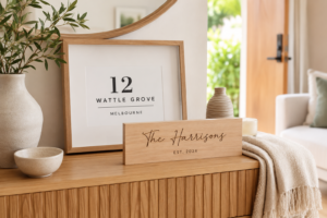 Personalised housewarming gifts including a custom address print and family name sign in a new home